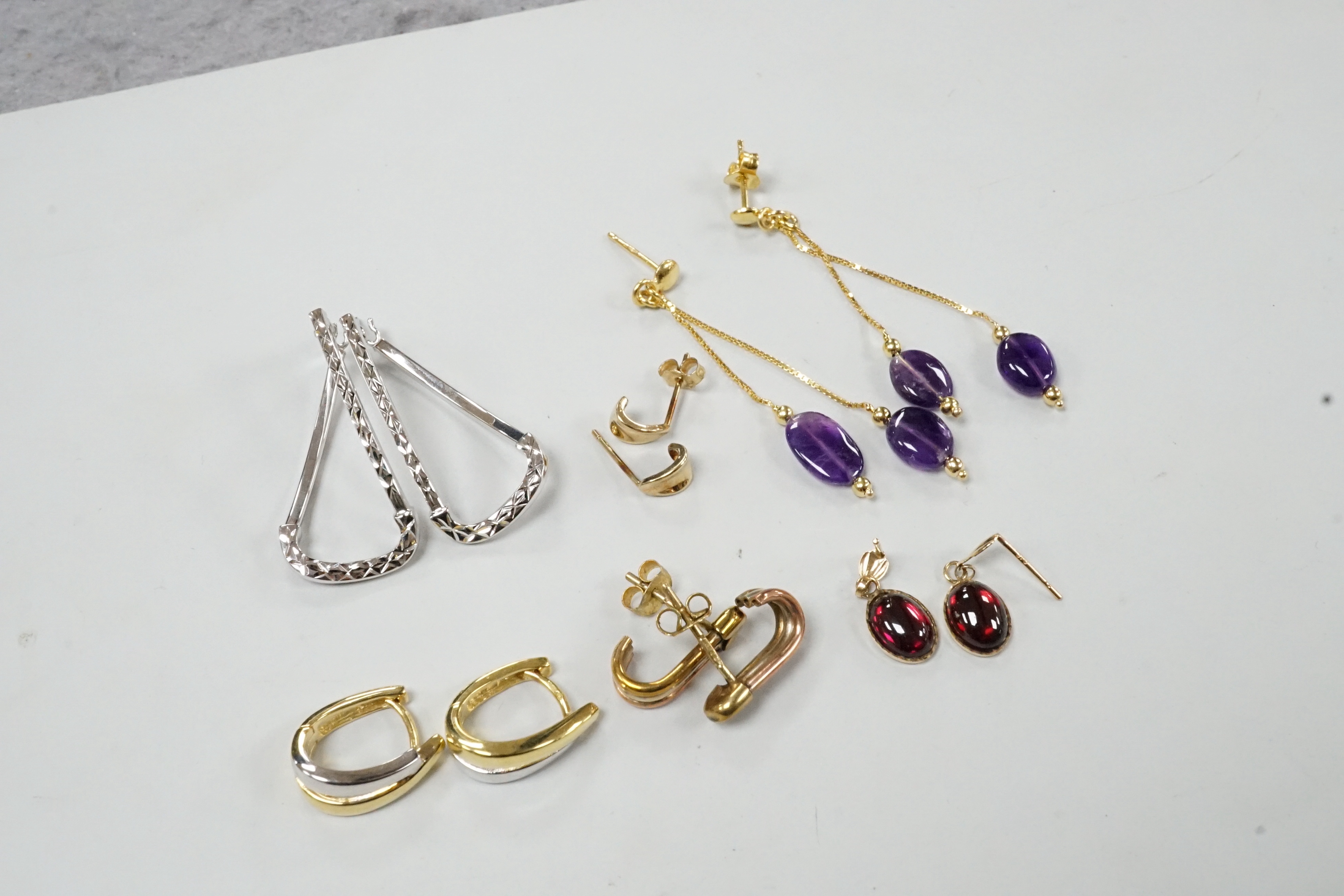 A modern pair of Italian 14k yellow metal and double drop amethyst set earrings, 50mm, gross weight 2.5 grams and five assorted pairs of 375 earrings, including one gem set, gross weight 8.3 grams.